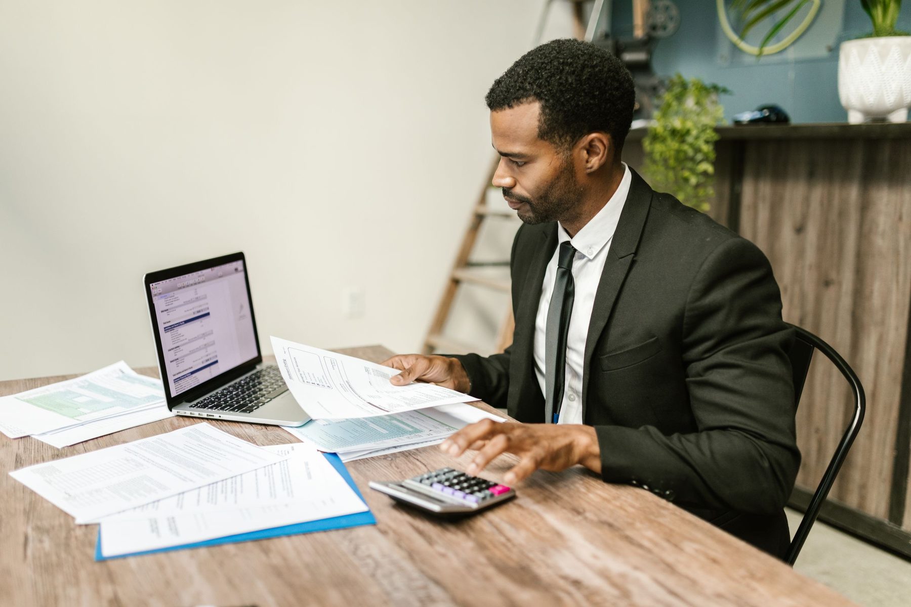 An accountant reviewing documents at his desk