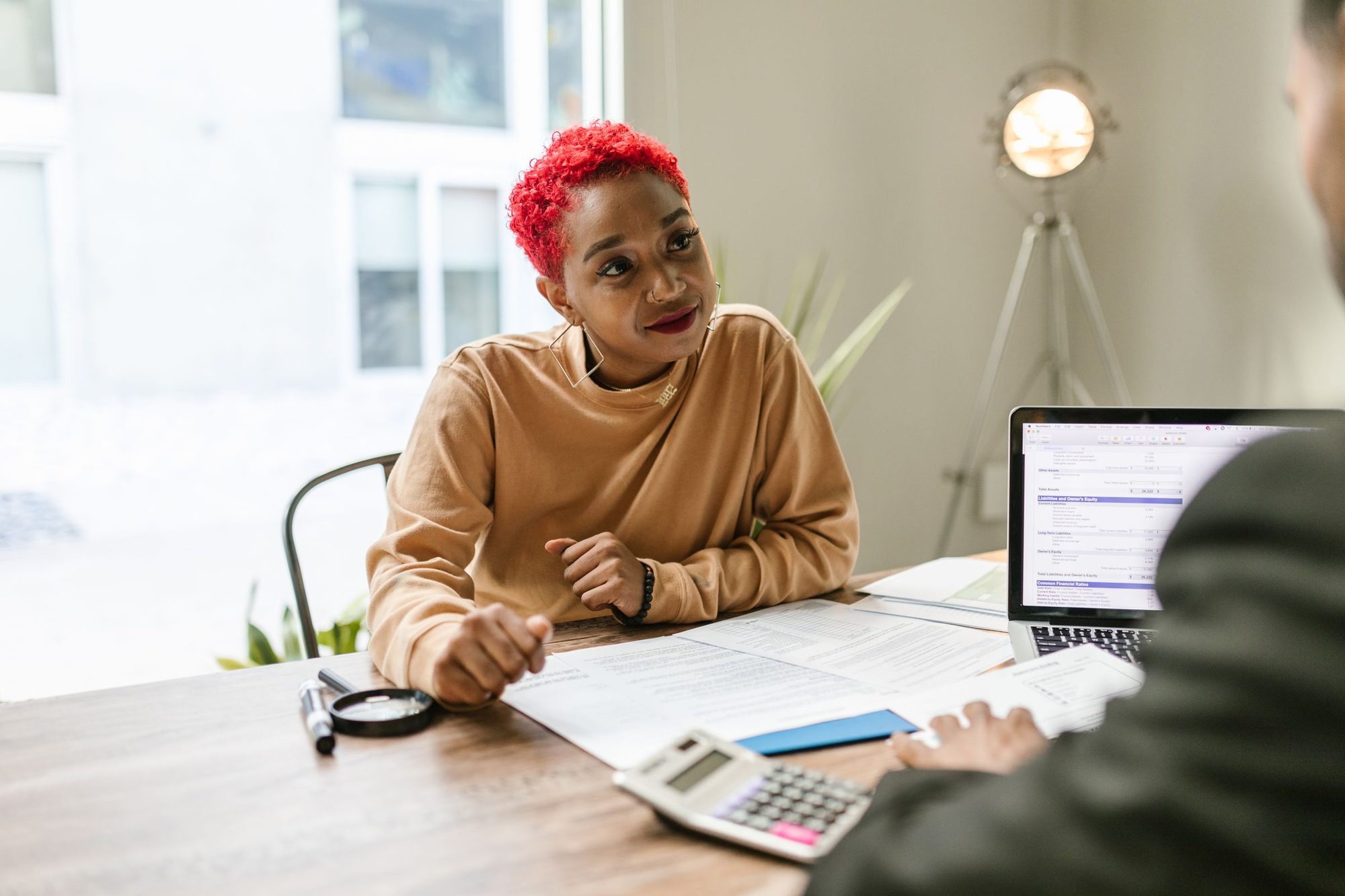 A client going over her tax paperwork with an advisor
