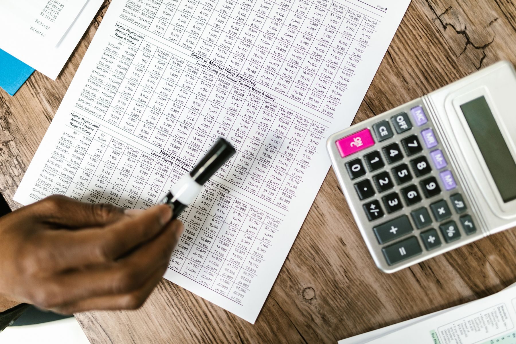 Checking figures on a ledger beside a calculator
