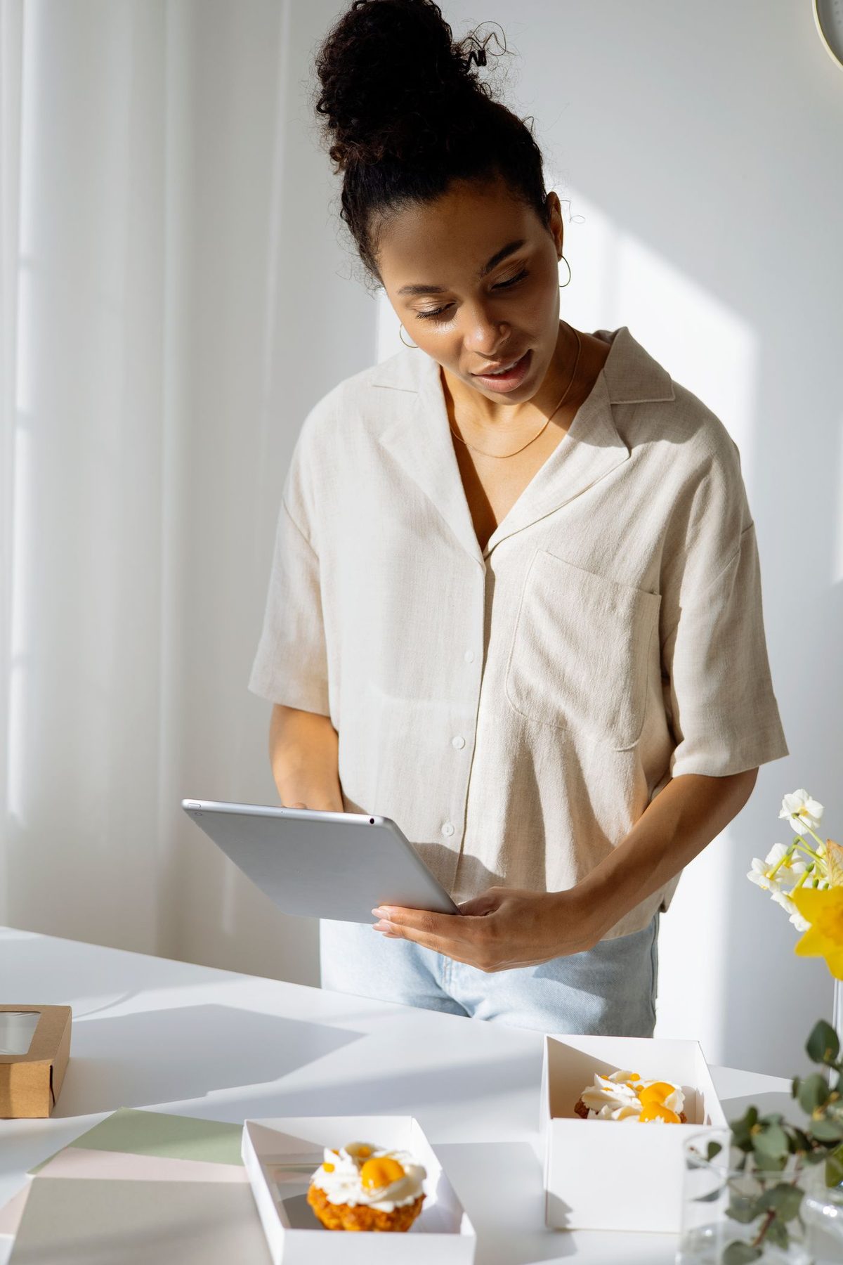 A baker planning orders on a tablet