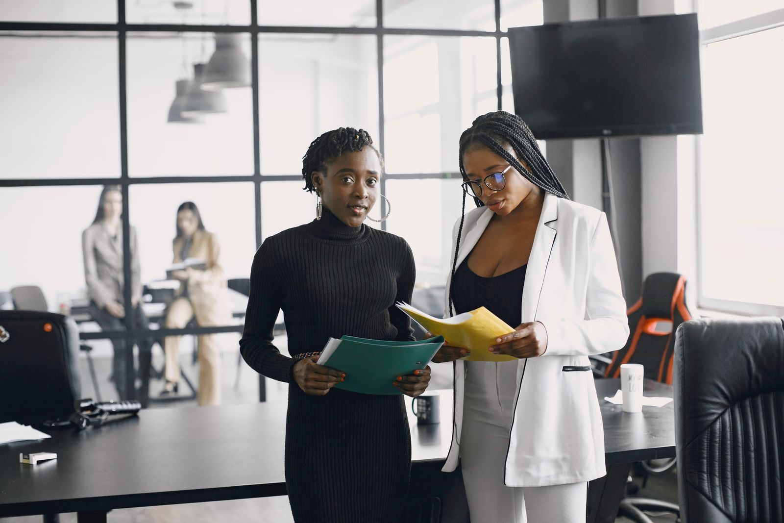 Two colleagues reviewing documents in an office